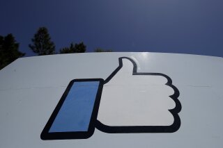 FILE - This April 25, 2019, file photo shows the thumbs-up "Like" logo on a sign at Facebook headquarters in Menlo Park, Calif. Facebook, following in Google’s footsteps, says it plans to invest $1 billion to support the news industry over the next three years. The social networking giant, which has been tussling with Australia over a law that would make social platforms pay news organizations, said it has invested $600 million since 2018 for news. (AP Photo/Jeff Chiu, File)