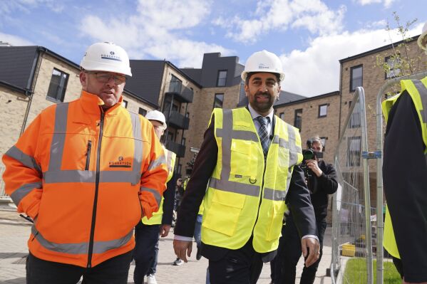 Scotland's First Minister Humza Yousaf, centre, visits the Hillcrest Homes housing development in Dundee, Scotland, Friday April 26, 2024. (Andrew Milligan/PA via AP)