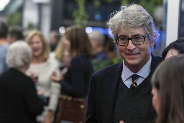 Alexander Payne mingles during "The Holdovers" premiere and reception fundraiser at Film Streams Dundee Theater, in Omaha, Neb., Saturday, Nov. 11, 2023. (Chris Machian/Omaha World-Herald via AP)