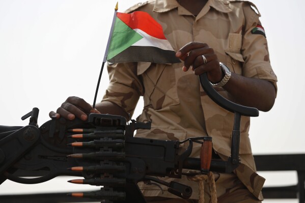 In this June 22, 2019 file photo, a Sudanese soldier from the Rapid Support Forces or RSF, stands on his vehicle during a military-backed tribe's rally, in the East Nile province, Sudan. (AP Photo/Hussein Malla, File)