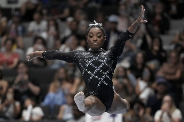 FILE - Simone Biles competes on the beam during the U.S. Gymnastics Championships, Aug. 27, 2023, in San Jose, Calif. Biles was named to the five-woman U.S. team that will head to the 2023 world championships in Belgium in early October. The 26-year-old has won 19 gold medals and 25 medals overall at the world championships during her career. (AP Photo/Godofredo A. Vásquez, File)