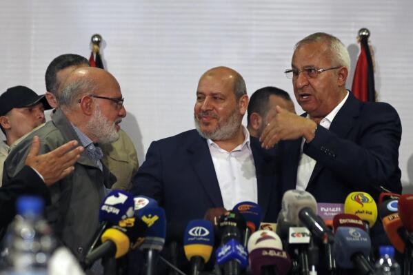 Khalil al-Hayeh, center, a senior figure in Hamas' political branch, attends a press conference with Abdulaziz Minawi, left, from the Islamic Jihad group, and Talal Naji leader of the Popular Front for the Liberation of Palestine - General Command, right, in Damascus, Syria, Wednesday, Oct. 19, 2022. Al-Hayeh was one of two senior officials from the Palestinian militant Hamas group who visited Syria's capital on Wednesday for the first time since they were forced to leave the war-torn country a decade ago over backing armed opposition fighters. (AP Photo/Omar Sanadiki)