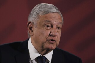 FILE - Mexican President Andres Manuel Lopez Obrador arrives for his daily news conference at the presidential palace in Mexico City, March 24, 2020. Lopez Obrador lashed out at social media platform YouTube on Monday, Feb. 26, 2024, for taking down part of his daily news briefing where he revealed a reporter’s phone number. (AP Photo/Marco Ugarte, File)