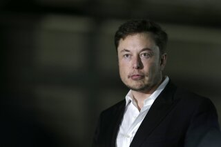 FILE- In this June 24, 2018, file photo Tesla CEO and founder of the Boring Company Elon Musk speaks at a news conference in Chicago. Shares of electric car maker Tesla Inc. tumbled over 9 percent as the markets opened Friday, Sept. 7, after the CEO smoked marijuana during a YouTube video podcast and the company’s accounting chief left after a month on the job. (AP Photo/Kiichiro Sato, File)