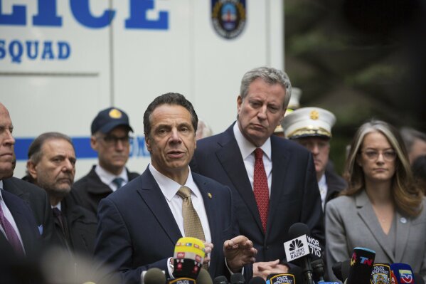 
              Mayor Bill de Blasio looks on as Gov. Andrew Cuomo delivers remarks during a news conference after NYPD personnel removed an explosive device from Time Warner Center Wednesday, Oct. 24, 2018, in New York.  The U.S. Secret Service says agents have intercepted packages containing "possible explosive devices" addressed to former President Barack Obama and Hillary Clinton.   (AP Photo/Kevin Hagen).
            