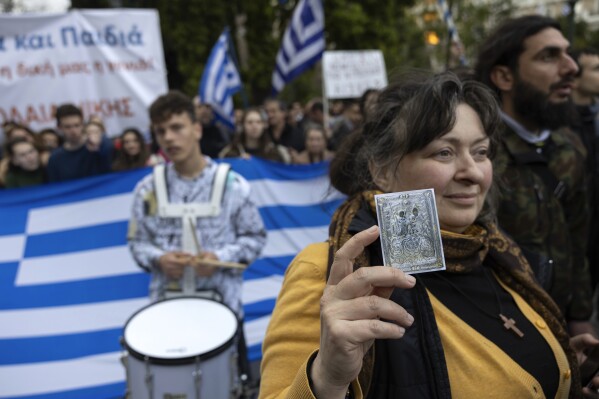 A protester holds a Holy Icon during a rally against same-sex marriage, at central Syntagma Square, in Athens, Greece, Sunday, Feb. 11, 2024. Lawmakers begin a debate Wednesday on a landmark bill to legalize same-sex marriage that would make Greece the first Orthodox Christian country to do so. (AP Photo/Yorgos Karahalis)