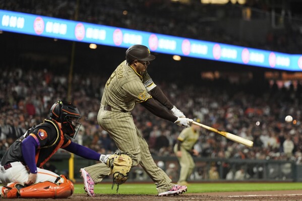 San Diego Padres' Manny Machado hits a two-run single during the ninth inning of a baseball game against the San Francisco Giants, Tuesday, June 3, 2025, in San Francisco. (AP Photo/Godofredo A. Vásquez)