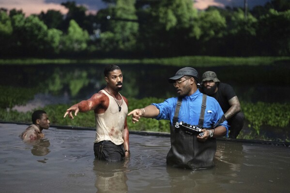 This image released by Warner Bros. Pictures shows actor Michael B. Jordan, left, and director-writer-producer Ryan Coogler on the set of "Sinners." (Eli Adé/Warner Bros. Pictures via AP)