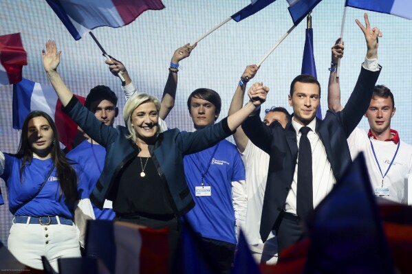 Leader of the French far-right National Rally Marine Le Pen, left and lead candidate of the party for the upcoming European election Jordan Bardella attend a political meeting on Sunday, June 2, 2024 in Paris. (AP Photo/Thomas Padilla)