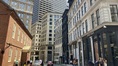 Pedestrians cross a street, Tuesday, July 11, 2023, in downtown Boston. The city is hoping a new program will encourage the conversion of underused downtown office buildings into residential use by offering building owners tax incentives. The push mirrors office-to-housing conversion efforts in other cities trying to breathe life back into downtown business districts that emptied out during the coronavirus pandemic and may never fully recover. (AP Photo/Steve LeBlanc)