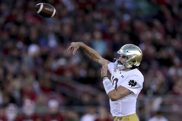 Notre Dame quarterback Sam Hartman throws a pass against Stanford during the first half of an NCAA college football game in Stanford, Calif., Saturday, Nov. 25, 2023. (AP Photo/Jed Jacobsohn)