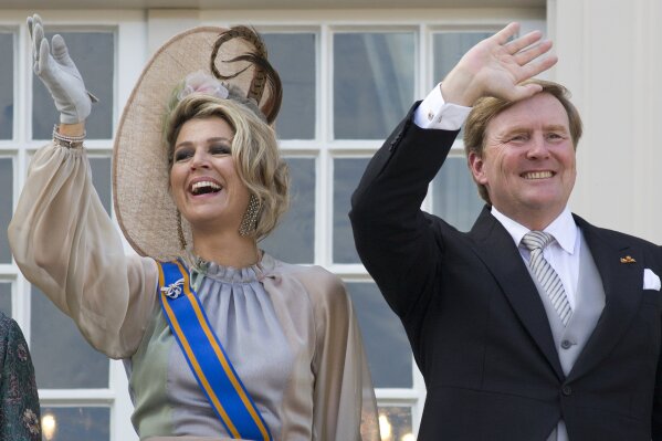 FILE - In this Tuesday, Sept. 18, 2018, file photo, Dutch King Willem-Alexander and Queen Maxima wave from the balcony of royal palace Noordeinde in The Hague, Netherlands, after a ceremony marking the opening of the parliamentary year with a speech by King Willem-Alexander outlining the government's budget plans for the year ahead. The Dutch king issued a video message Wednesday saying "with sorrow in the heart" that he regrets flying to Greece for a family vacation last week, a trip that was quickly broken off amid public uproar back home where people are being urged to stay home as much as possible to battle the coronavirus. (AP Photo/Peter Dejong, File)