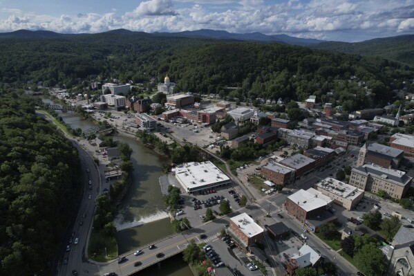 The Winooski River flows in Montpelier, Vt., July 31, 2023. The mostly gutted shops and restaurants in downtown Montpelier are considering where and how to rebuild in an era when extreme weather is occurring more often. (AP Photo/Brittany Peterson)