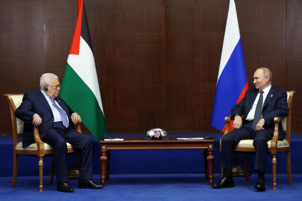 Russian President Vladimir Putin, right, and Palestinian President Mahmoud Abbas speak, during their meeting on the sidelines of the Conference on Interaction and Confidence Building Measures in Asia (CICA) summit, in Astana, Kazakhstan, Thursday, Oct. 13, 2022. (Vyacheslav Prokofyev, Sputnik, Kremlin Pool Photo via AP)