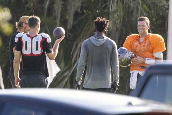 Tampa Bay Buccaneers NFL football quarterback Tom Brady, far right, is seen along with other players during a private workout Tuesday, June 23, 2020, at Berkeley Preparatory School in Tampa, Fla. (Chris Urso/Tampa Bay Times via AP)
