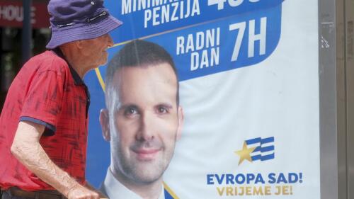 A man walks past a pre-election billboard showing leader of the Europe Now movement, financial expert Milojko Spajic in Podgorica, Montenegro, Friday, June 9, 2023. Montenegro is holding an early parliamentary election Sunday, a vote that could provide indications of whether the small NATO member in the Balkans will overcome the deep political divisions and instability that have hampered its route to joining the European Union. (AP Photo/Risto Bozovic)