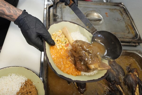 A sampling of East African cuisine is prepared at the Baobab Fare restaurant, Friday, May 24, 2024, in Detroit. For Hamissi Mamba and Nadia Nijimbere _ who own Baobab Fare in Detroit _ a win among the five finalists in the James Beard's "Outstanding Restaurateur" category would be personal. The couple, who fled Burundi about a decade ago, faced a difficult road as refugees opening a business in America. (AP Photo/Carlos Osorio)