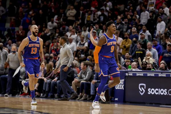 New York Knicks guard RJ Barrett (9) and guard Evan Fournier (13) react after a basket against the New Orleans Pelicans in the fourth quarter of an NBA basketball game in New Orleans, Saturday, Oct. 30, 2021. (AP Photo/Derick Hingle)