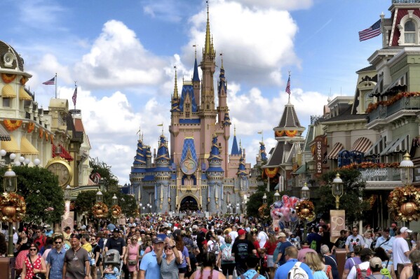 FILE - Crowds fill Main Street USA in front of Cinderella Castle at the Magic Kingdom on the 50th anniversary of Walt Disney World in Lake Buena Vista, Fla., on Oct. 1, 2021. Almost a year after Florida lawmakers passed a law giving Florida’s governor control over Walt Disney World’s governing district, Gov. Ron DeSantis on Thursday, Feb. 22, 2024, called the takeover a success, despite an exodus of workers, ongoing litigation and accusations of cronyism by the new leadership. (Joe Burbank/Orlando Sentinel via AP, File)/Orlando Sentinel via AP)