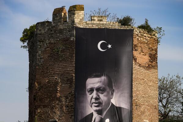 A giant banner of Turkish President and People's Alliance's presidential candidate Recep Tayyip Erdogan is displayed on an historical city wall, in Istanbul, Turkey, Saturday, April 22, 2023. Two opposing visions for Turkey’s future are on the ballot when voters return to the polls Sunday for a runoff presidential election, which will decide between an increasingly authoritarian incumbent President Recep Tayyip Erdogan and challenger Kemal Kilicdaroglu, who has pledged to restore democracy. (AP Photo/Emrah Gurel)