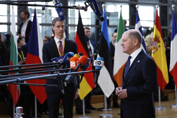 Germany's Chancellor Olaf Scholz speaks with the media as he arrives for an EU Summit at the European Council building in Brussels, Thursday, March 6, 2025. (AP Photo/Omar Havana)