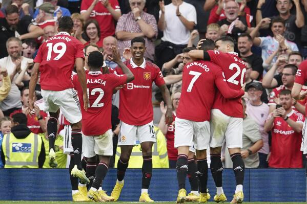 Manchester United's Marcus Rashford, centre, celebrates after scoring his side's second goal during the English Premier League soccer match between Manchester United and Arsenal at Old Trafford stadium, in Manchester, England, Sunday, Sept. 4, 2022. (AP Photo/Dave Thompson)