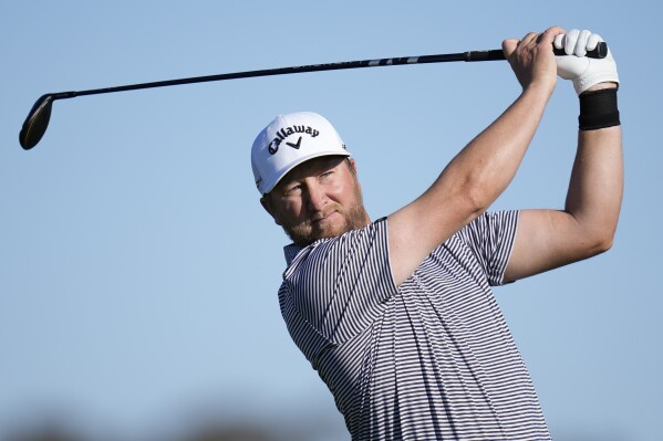 FILE - Brice Garnett watches his tee shot on the second hole of the South Course at Torrey Pines during the second round of the Farmers Insurance Open golf tournament, on Jan. 26, 2023, in San Diego. Garnett went from limited PGA Tour status to full access the next three years by winning the Puerto Rico Open. (AP Photo/Gregory Bull)