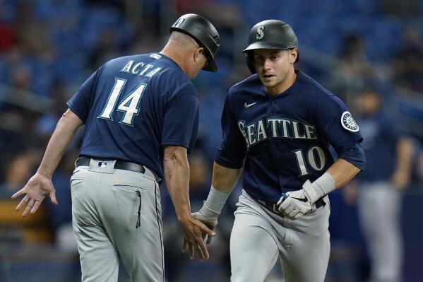 Seattle Mariners' Jarred Kelenic (10) celebrates with third base coach Manny Acta (14) after his solo home run off Tampa Bay Rays pitcher Luis Patino during the fourth inning of a baseball game Tuesday, Aug. 3, 2021, in St. Petersburg, Fla. (AP Photo/Chris O'Meara)