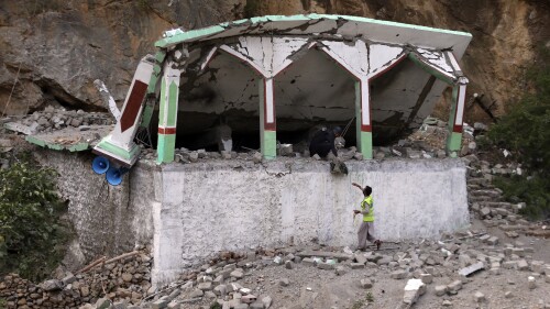 Security personnel inspect the site of suicide bomber attack inside a roadside mosque in the Khyber district in Khyber Pakhtunkhwa province, of Pakistan, Tuesday, July 25, 2023. A suicide bomber blew himself up inside a roadside mosque when a police officer tried to arrest him after a chase in northwestern Pakistan near the Afghan border on Tuesday, killing the officer, police said. (AP Photo/Muhammad Sajjad)