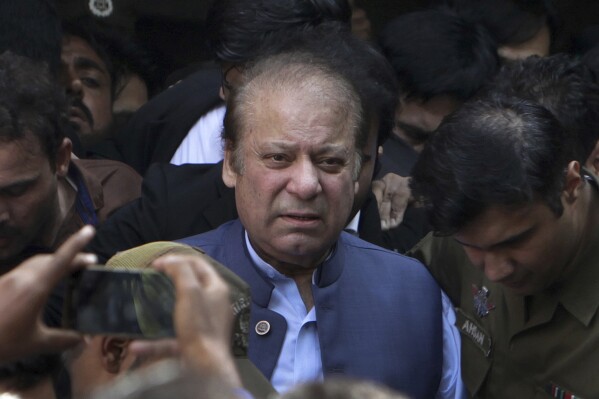 FILE - Former Pakistani Prime Minister Nawaz Sharif leaves a court in Lahore, Pakistan, on Oct. 8, 2018. Officials say Pakistan’s former Prime Minister Nawaz Sharif has sought protection from arrest from a court days before his planned return to the country. Sharif is expected to return home on Saturday, Oct. 21, 2023 from the United Arab Emirates, where he's been living in self-imposed exile. He is currently a fugitive from justice. (AP Photo/K.M. Chaudary, File)