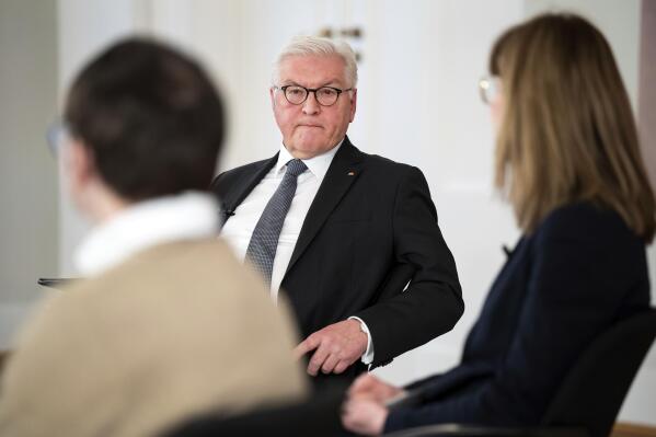 German President Frank-Walter Steinmeier, center. attends a discussion about the pros and cons of mandatory vaccination to overcome the Covid 19 pandemic in Germany with guests, as well as digitally connected participants, at Bellevue Palace in Berlin, Germany, Wednesday, Jan. 12, 2022. (Bernd von Jutrczenka/dpa via AP)