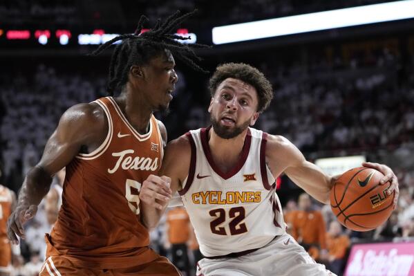 Iowa State guard Gabe Kalscheur (22) is fouled by Texas guard Marcus Carr (5) while driving to the basket during the second half of an NCAA college basketball game, Tuesday, Jan. 17, 2023, in Ames, Iowa. (AP Photo/Charlie Neibergall)