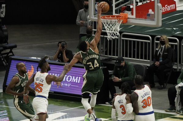 Milwaukee Bucks' Giannis Antetokounmpo is fouled as he dunks during the first half of an NBA basketball game against the New York Knicks Thursday, March 11, 2021, in Milwaukee. (AP Photo/Morry Gash)