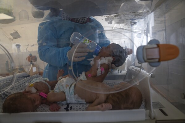 A nurse prepares premature babies for transport to Egypt after they were evacuated from Shifa Hospital in Gaza City to a hospital in Rafah, Gaza Strip, Monday, Nov. 20, 2023. (AP Photo/Fatima Shbair)