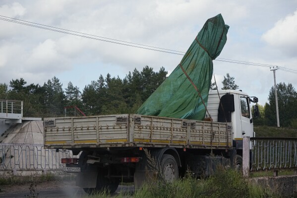 A truck carries a part of a private jet crashed near the village of Kuzhenkino, Tver region, Russia, Friday, Aug. 25, 2023. A preliminary U.S. intelligence assessment has found that the plane crash presumed to have killed Wagner leader Yevgeny Prigozhin was intentionally caused by an explosion. (AP Photo/Alexander Zemlianichenko)