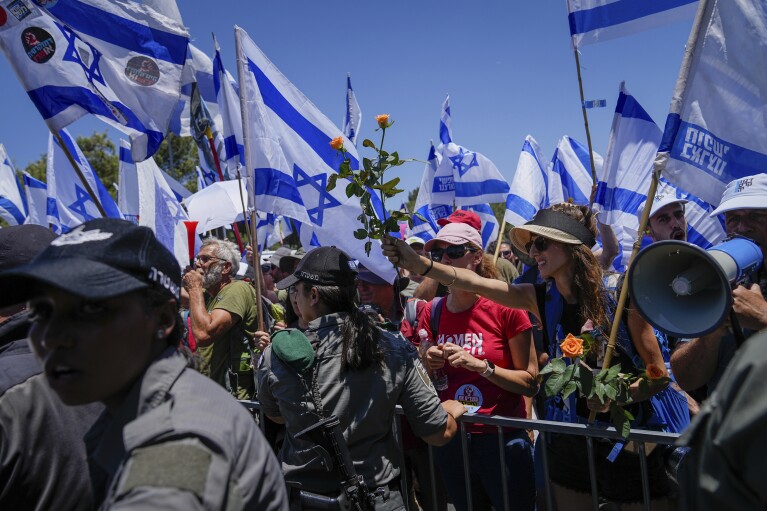 Israelis protest against plans by Prime Minister Benjamin Netanyahu's government to overhaul the judicial system, outside the Knesset, Israel's parliament, in Jerusalem, Monday, July 24, 2023. (AP Photo/Ohad Zwigenberg)