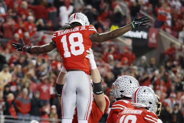 Ohio State receiver Marvin Harrison (18) celebrates after his touchdown against Minnesota during the second half of an NCAA college football game Saturday, Nov. 18, 2023, in Columbus, Ohio. (AP Photo/Jay LaPrete)