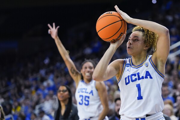 UCLA guard Kiki Rice (1) attempts a 3-point basket as guard Camryn Brown (35) gestures during the second half of the team's first-round college basketball game against California Baptist in the women's NCAA Tournament, Saturday, March 23, 2024, in Los Angeles. (AP Photo/Ryan Sun)