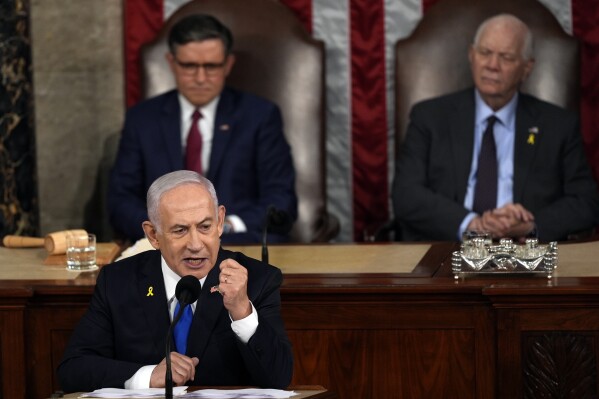 Israeli Prime Minister Benjamin Netanyahu speaks to a joint meeting of Congress at the Capitol in Washington, Wednesday, July 24, 2024, as House Speaker Mike Johnson of La., and Senate Foreign Relations Chair Ben Cardin, D-Md., listen. (ĢӰԺ Photo/Julia Nikhinson)