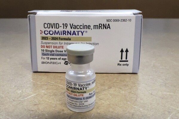 FILE - Comirnaty, a new Pfizer/BioNTech vaccination booster for COVID-19, is displayed at a pharmacy in Orlando, Fla., on Friday, Sept. 15, 2023. Older U.S. adults should roll up their sleeves for another COVID-19 shot, even if they received a booster in the fall, an influential government advisory panel said Wednesday, Feb. 28, 2024. (Joe Burbank/Orlando Sentinel via AP)