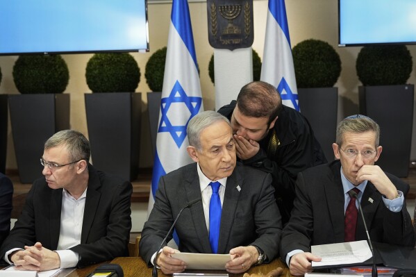 Israeli Prime Minister Benjamin Netanyahu, center, chairs a cabinet meeting at the Kirya military base, which houses the Israeli Ministry of Defence, in Tel Aviv, Israel, Sunday, Dec . 24, 2023. (AP Photo/Ohad Zwigenberg, Pool)