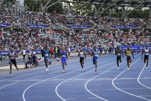 South Africa's Luxolo Adams, left, leads the back to win the 200 meters men during the Diamond League athletics meeting at Charlety stadium in Paris, Saturday, June 18, 2022. (AP Photo/Michel Euler)