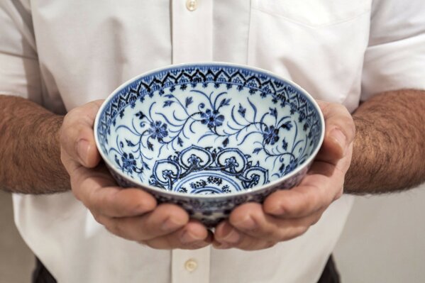 This photo, provided by Sotheby's, in New York, on Tuesday, March 2, 2021, shows a small porcelain bowl bought for $35 at a Connecticut yard sale that turned out to be a rare, 15th century Chinese artifact worth between $300,000 and $500,000. The bowl was auctioned off for nearly $722,000 at Sotheby's Auction of Important Chinese Art, in New York, on March 17. (Sotheby's via AP)