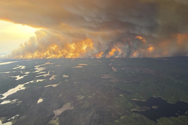 A Canadian prairie city virtually deserted as fires rage and thousands more evacuees expected