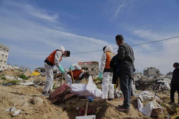 The bodies of Palestinians killed during the Israel-Hamas war and were buried in a mass grave at Shifa Hospital yard are exhumed for identification and reburial in Gaza City's official cemeteries, on Thursday, March 13, 2025. (AP Photo/Abdel Kareem Hana)