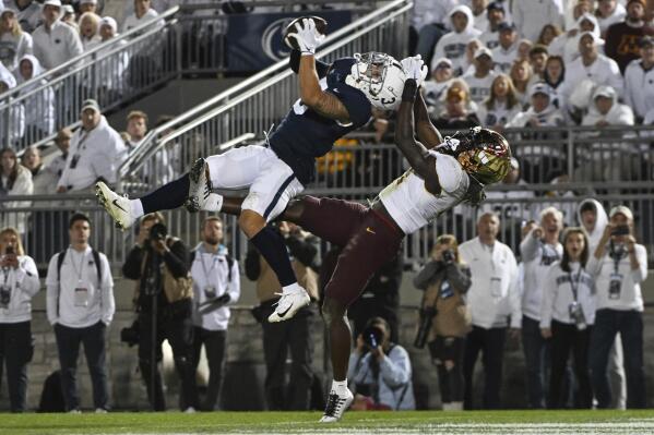 Penn State wide receiver Parker Washington (3) catches a 35-yard touchdown pass as Minnesota defensive back Terell Smith (4) defends during the second half of an NCAA college football game Saturday, Oct. 22, 2022, in State College, Pa. (AP Photo/Barry Reeger)