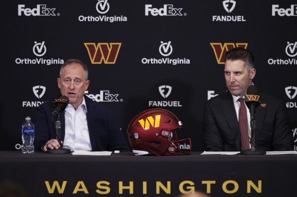 Washington Commanders owner Josh Harris, left, speaks after introducing new general manager Adam Peters, right, during an NFL football press conference, Tuesday, Jan. 16, 2024, in Ashburn, Va. (AP Photo/Luis M. Alvarez)