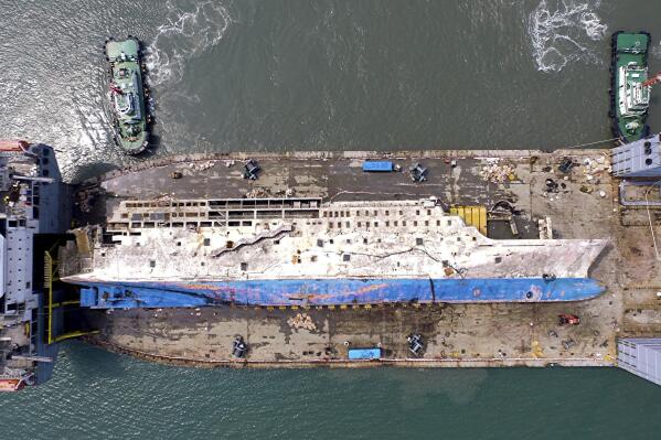 In this Friday, March 31, 2017, photo, the sunken ferry Sewol is seen on a semi-submersible transport vessel in waters off Mokpo, South Korea. The corroding 6,800-ton ferry raised from the bottom of the sea last week arrived at a South Korean port Friday, where it will be searched for the remains of nine missing passengers from a 2014 sinking. (Kim Do-hun/Yonhap via AP, File)
