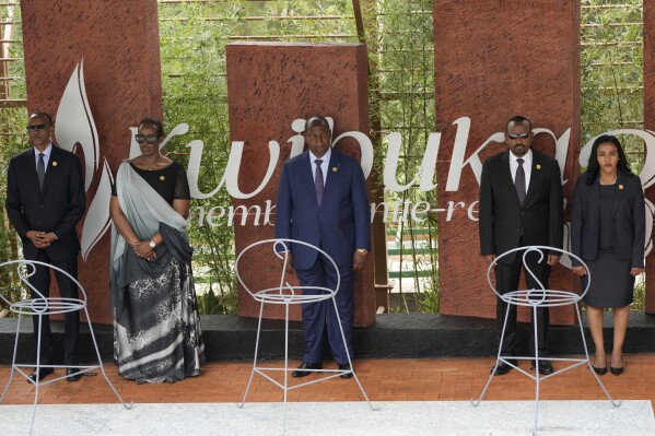 Rwandan President Paul Kagame, left and his wife, first lady Jeannette Kagame, President of the Central African Republic Faustin-Archange Touadérale, centre and Ethiopia's Prime Minister Abiy Ahmed and his wife Zinash Tayachew stand, during a ceremony to mark the 30th anniversary of the Rwandan genocide, held at the Kigali Genocide Memorial, in Kigali, Rwanda, Sunday, April 7, 2024. Rwandans are commemorating 30 years since the genocide in which an estimated 800,000 people were killed by government-backed extremists, shattering this small east African country that continues to grapple with the horrific legacy of the massacres. (AP Photo/Brian Inganga)