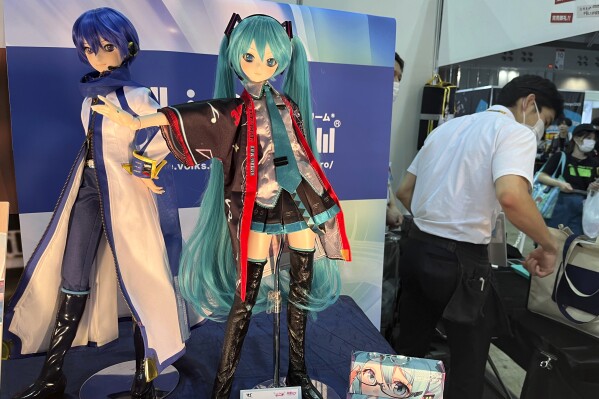 A figure of Hatsune Miku is displayed at an event at a Tokyo suburban hall, Makuhari Messe, in Chiba, Japan, Friday, Sept. 1, 2023, in celebration of her 16th birthday. Hatsune Miku has always been 16 years old and worn long aqua ponytails. She is Japan's most famous Vocaloid, a computer-synthesized singing voice software that, in her case, comes with a virtual avatar. (AP Photo/Yuri Kageyama)
